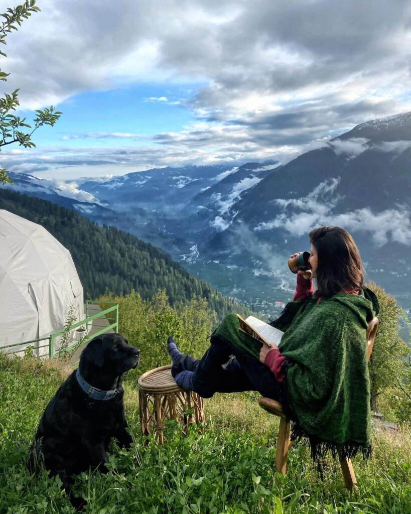 Traveler relaxing in nature at GlampEco Manali – glamping stay in the Himalayan mountains
