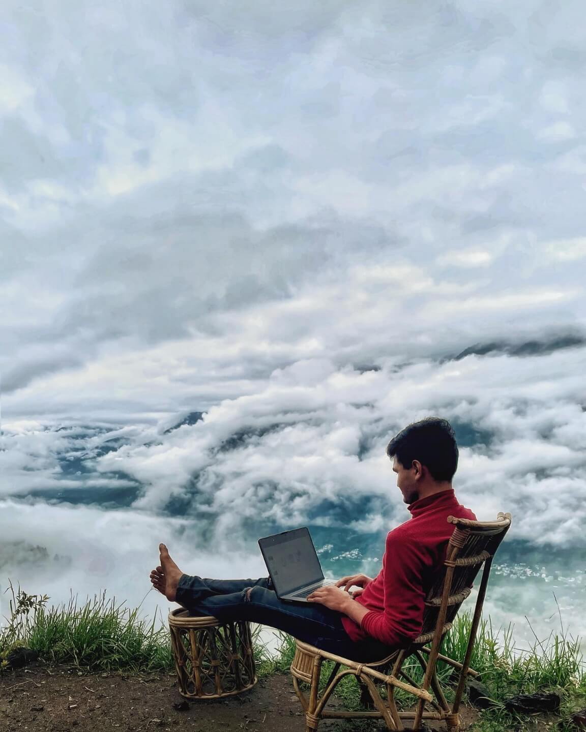 Digital nomad working over the clouds in the mountains at GlampEco Manali
