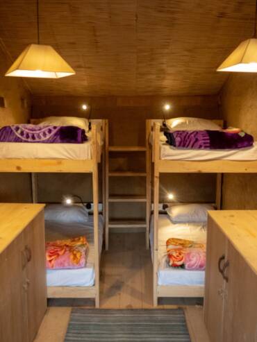 Bunkbeds in GlampEco's mudhouse hostel dormitory room in Manali