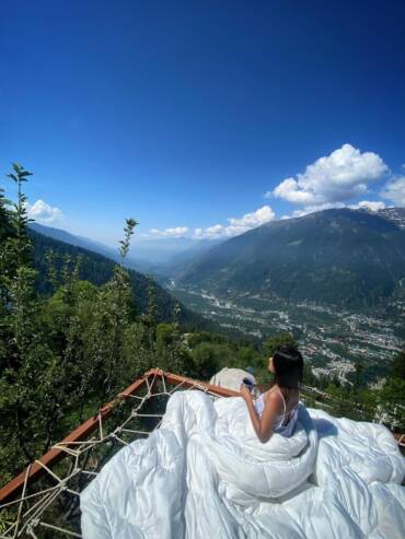 Guest relaxing at a luxury relaxing outdoor dome space of GlampEco Manali