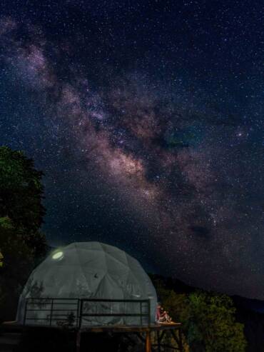 Couple observing milky way from their luxury dome at GlampEco Manali