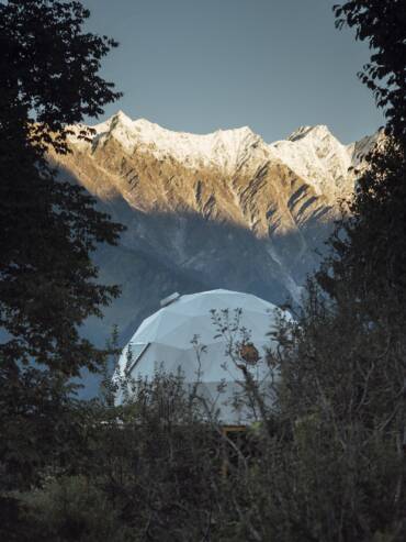 Snowy mountain views from the luxurious bubble dome at GlampEco