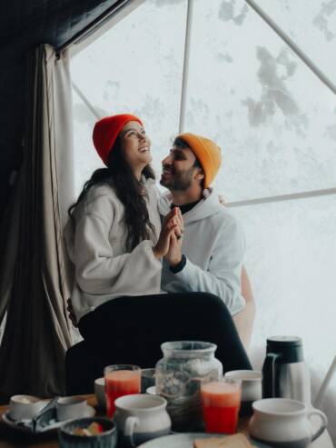 A couple enjoying room service in a luxury standard dome at GlampEco Manali