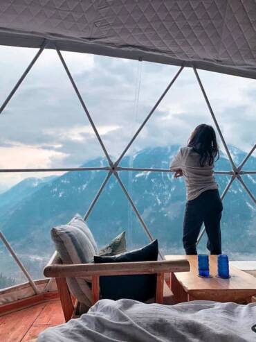 Traveler at GlampEco's luxury standard dome with breathtaking Manali mountain views